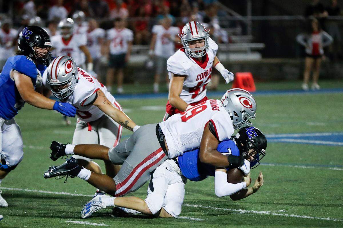 Corbin’s Jerod Smith (99) tackles Lexington Catholic quarterback Jackson Wasik (7) during a game at Lexington Catholic on Sept. 1.