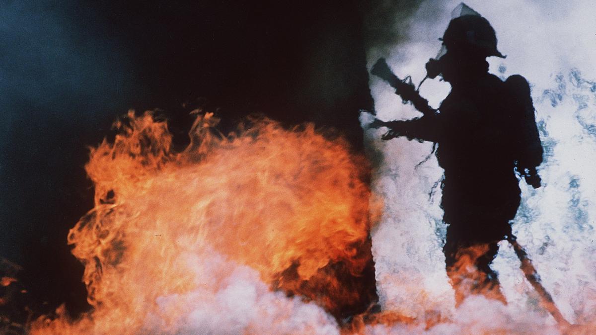 A Lexington firefighter works inside a burning building in rural Fayette County, Ky.
