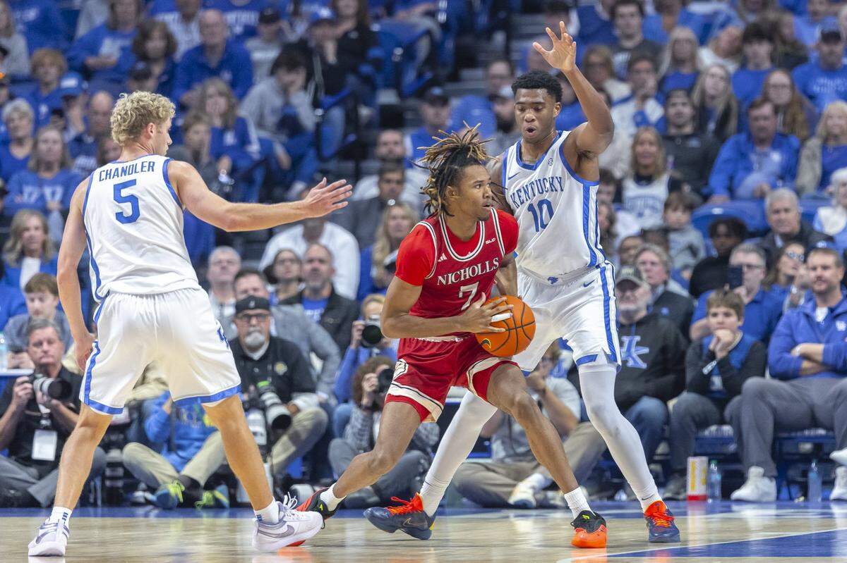 Kentucky guard Collin Chandler (5) and forward Brandon Garrison (10) defend Nicholls forward Grant Sanders (7) during the Wildcats’ season-opening win Tuesday at Rupp Arena.