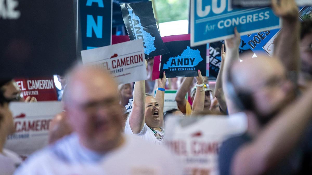 Kentucky Gov. Andy Beshear supporters hold signs and cheer during the annual St. Jerome Fancy Farm Picnic in Fancy Farm, Ky., on Saturday, Aug. 5, 2023.