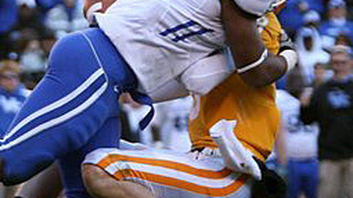 Kentucky Wildcats linebacker Ronnie Sneed tackles Tennessee Volunteers quarterback Tyler Bray during the fourth quarter of Kentucky at the University of Tennessee Nov. 27, 2010.