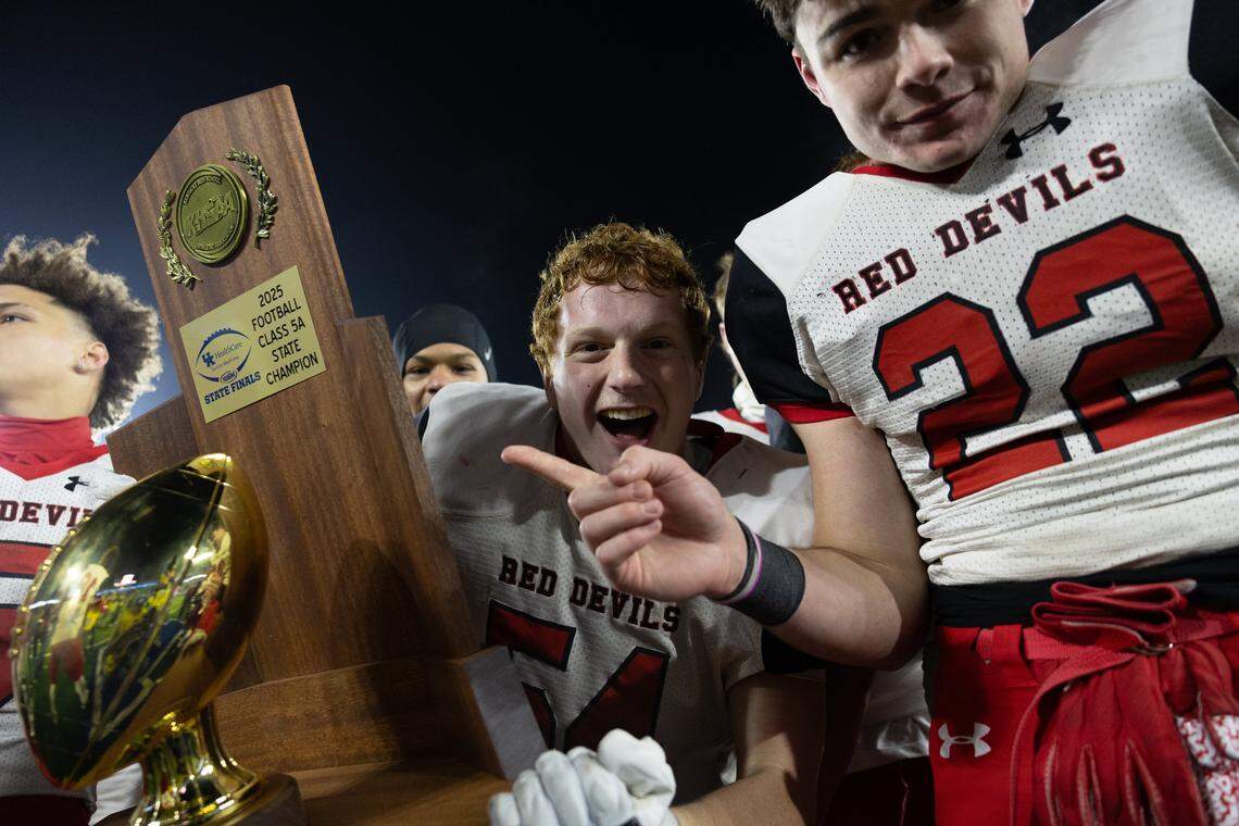 Owensboro's Andrew Johnson (54) and Owensboro's Evan Hampton (22) with the trophy after the Class 5A UK HealthCare Sports Medicine State Football Finals Saturday, December 6th, 2025 at Kroger Field in Lexington KY