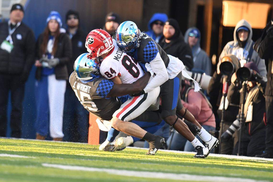 Kentucky’s Jordan Wright and Keidron Smith tackled Georgia’s Ladd McConkey during last year’s 16-6 Bulldogs win over the Wildcats at Kroger Field. On Saturday night, UK will try to end UGA’s 13-game winning streak in their series.
