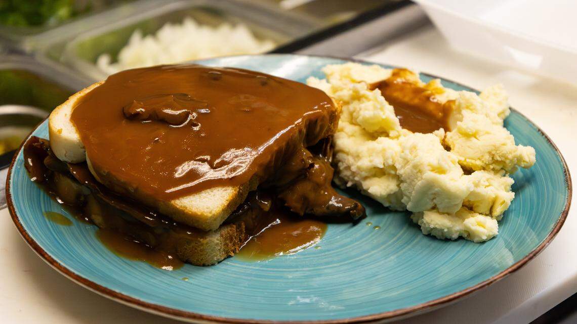 Shelby Keith fixes a roast beef sandwich with mashed potatoes, smothered in mushroom gravy at Shelby's Diner on Nov. 21, 2025, in Frankfort, Ky.