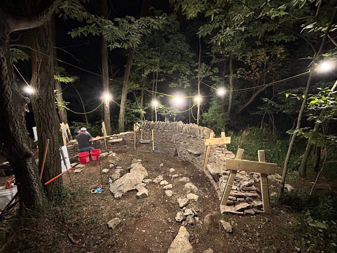 Masons and volunteers work on a dry stone wall at McConnell Springs as part of the Dry Stone Conservancy 24-hour walling marathon in September 2024, one of the nonprofit’s most popular events.