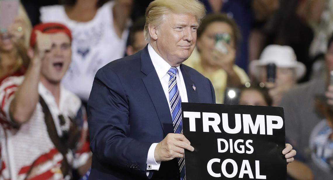 President Donald Trump holds a sign before speaking during a rally Thursday, Aug. 3, 2017, in Huntington, W.Va. (AP Photo/Darron Cummings)