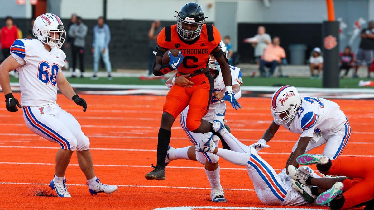 Paris’ Elijah Webb (6) breaks the tackles of Frankfort defenders on Friday at Blanton Collier Stadium in Paris.