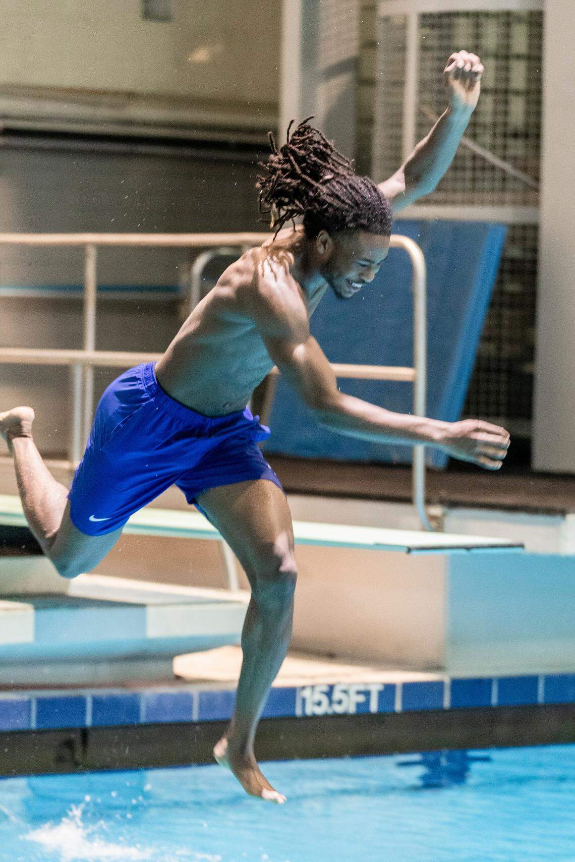 Cason Wallace jumps off a diving board at the Lancaster Aquatic Center on UK’s campus.