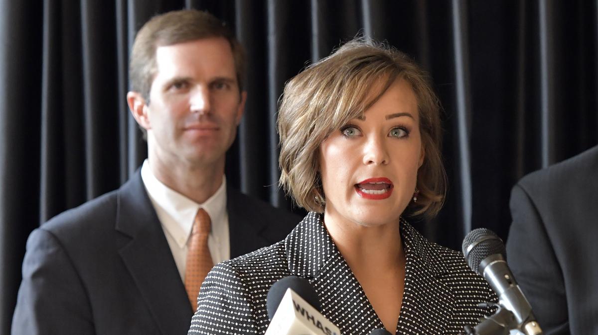 As Kentucky Attorney General Andy Beshear looks over her shoulder, Jacqueline Coleman speaks to a gathering of supporters following the announcement of her candidacy for Lt. Governor at the Kentucky Center for African American Heritage in Louisville, Ky, Monday, July 9,  2018.