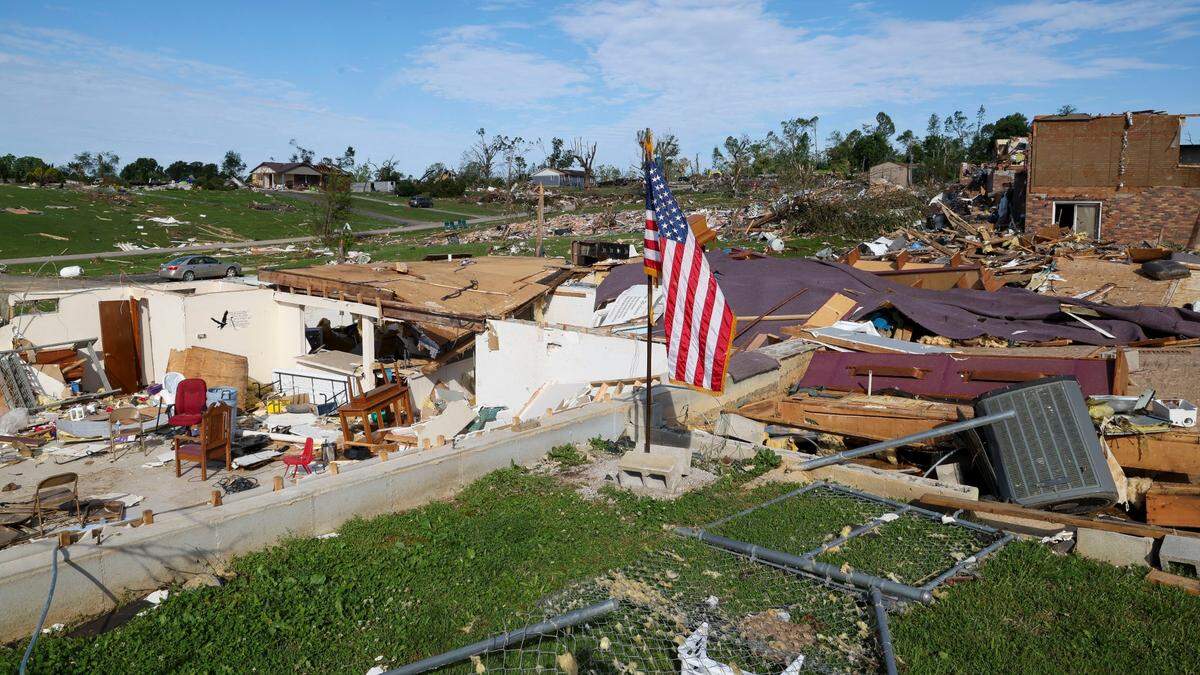 A flag sits at the site of the Sunshine Hill Baptist Church in the Sunshine Hills neighborhood, Sunday, May 18, 2025 in London, Ky. Two days earlier, a deadly tornado ripped through the neighborhood destroying homes.