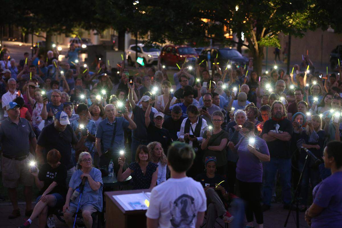 People held lights Friday evening during Lights For Liberty: A Vigil to End Human Detention Camps at Courthouse Plaza in Lexington.