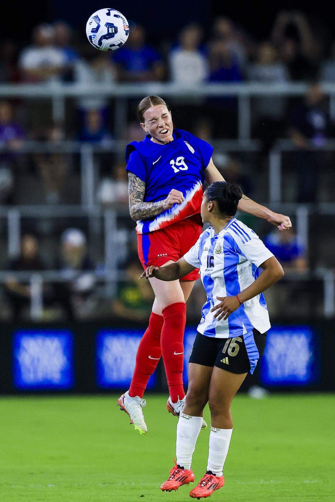 United States midfielder Hal Hershfelt (19) heads the ball against Argentina defender Sofia Dominguez (16) on Wednesday night.