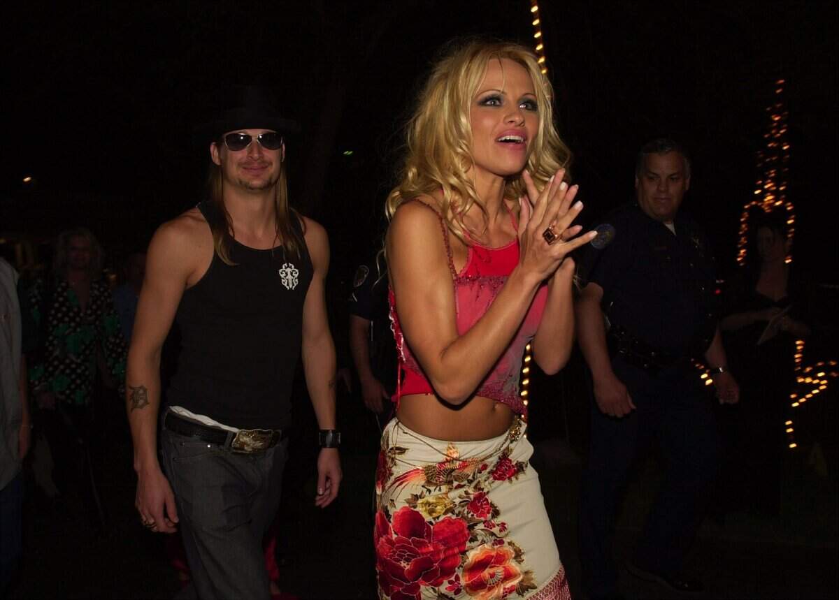Pamela Anderson , right, reacts to watching some of the Cinderella themed  entertainment  as she arrives at the Barnstable Brown derby eve party with Kid Rock on  friday  May 4, 2001 in Louisville, Ky.