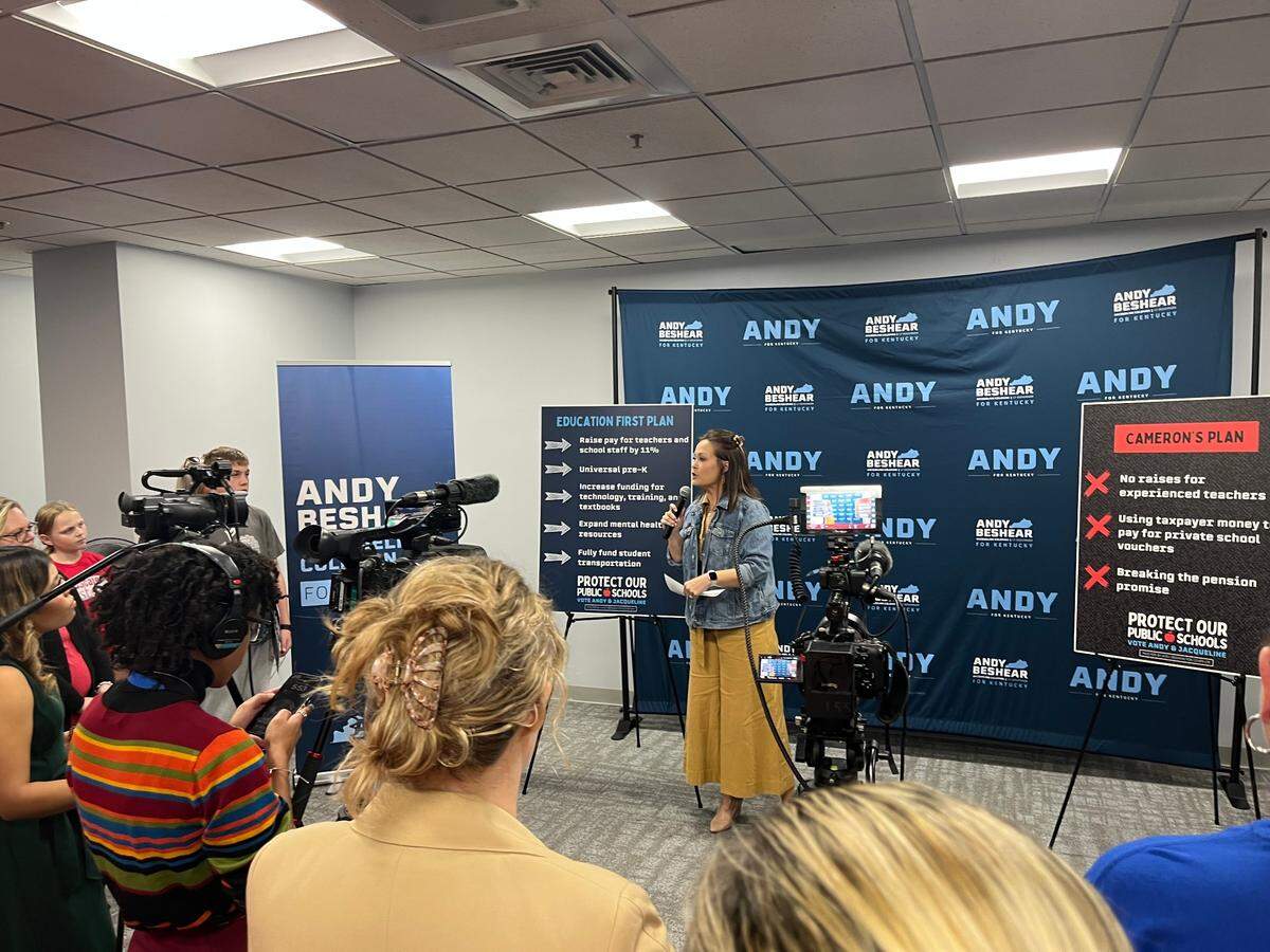 Lt. Gov. Jacqueline Coleman brought signs promoting Beshear’s education plan and deriding Cameron’s to an event at the Lexington Public Library.
