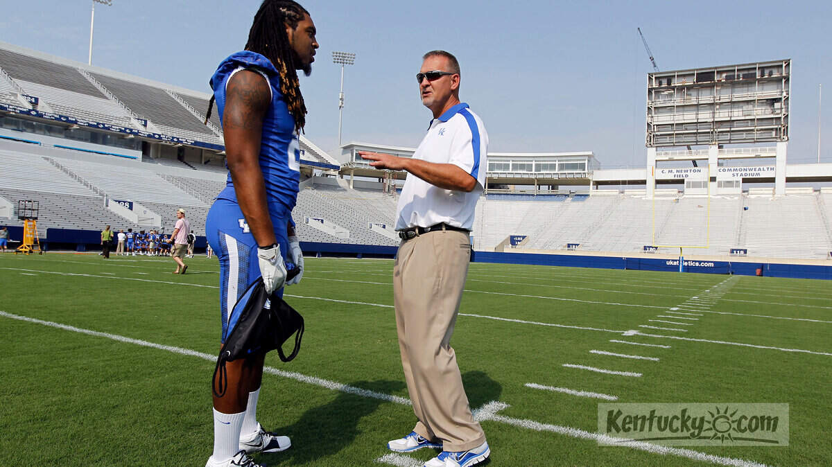 Senior Winston Guy talked with linebackers coach Chuck Smith during the University of Kentucky football media day held at Commonwealth Stadium in Lexington, Ky., Friday, August 5, 2011. UK opens the season September 1 on the road in Nashville, Tn. against Western Kentucky University. Charles Bertram | Staff