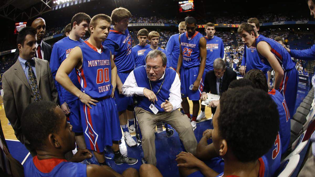 Montgomery County Coach Happy Osborne, center, talked to his team during a timeout Thursday at the Sweet Sixteen in Rupp Arena. Osborne's Indians, led by Omar Prewitt's 29 points, turned back Warren Central 71-63, advancing to play Friday.    