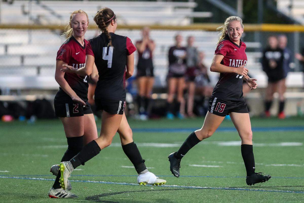 Lillie Kluesner (19) smiled at teammate Shae Robertson (4) after a Tates Creek goal during a soccer game last fall. Kluesner has been a starter for longer on Creek’s softball team, but plans to make soccer her primary sport between the two at the University of Pikeville.