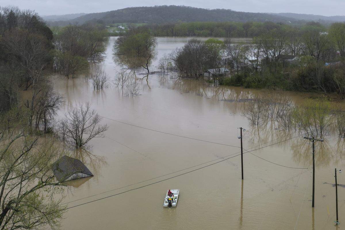 An Owen County Search and Rescue vessel passes by the flooded community of Monterey, Ky., on Sunday, April 6, 2025.