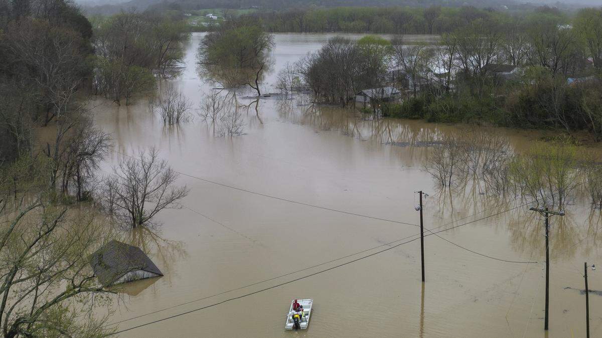 An Owen County Search and Rescue vessel passes by the flooded community of Monterey, Ky., on Sunday, April 6, 2025.