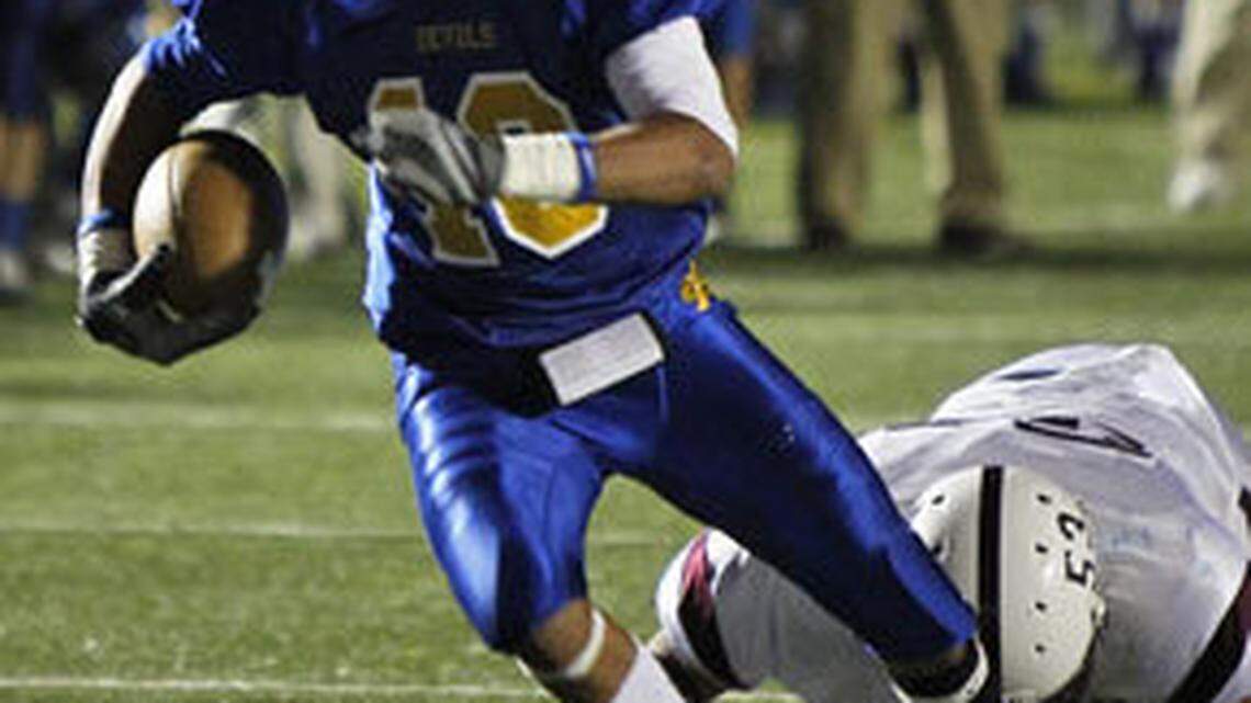 Henry Clay's Vinny Miller ran away from the tackle of Tates Creeks  William Hardin for a second quarter gain as Henry Clay leads 36-22 in the third quarter.