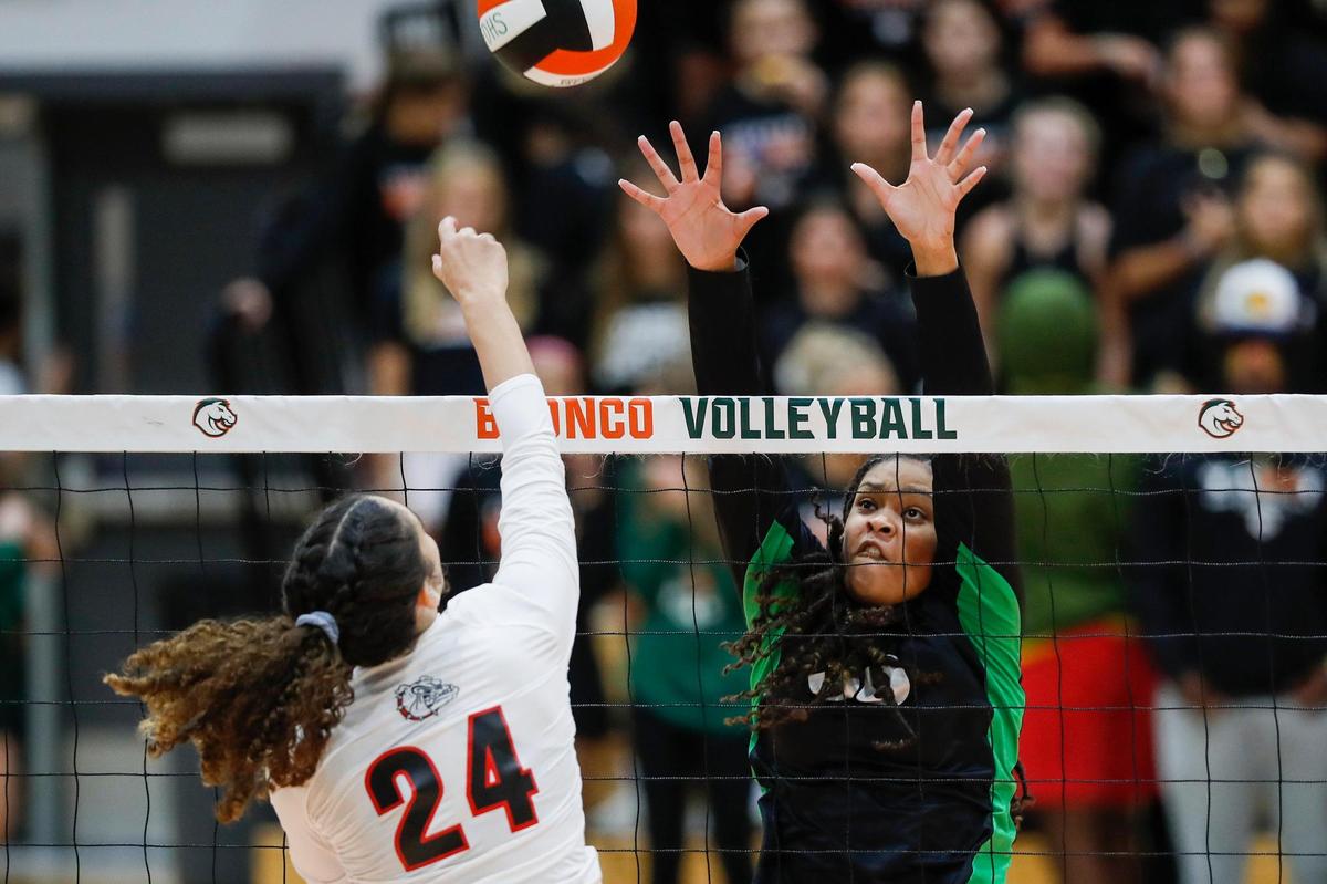 Paul Laurence Dunbar’s Nyla Gains (24) spikes the ball against Frederick Douglass’s Torii Starks (30) during a match on Aug. 30.