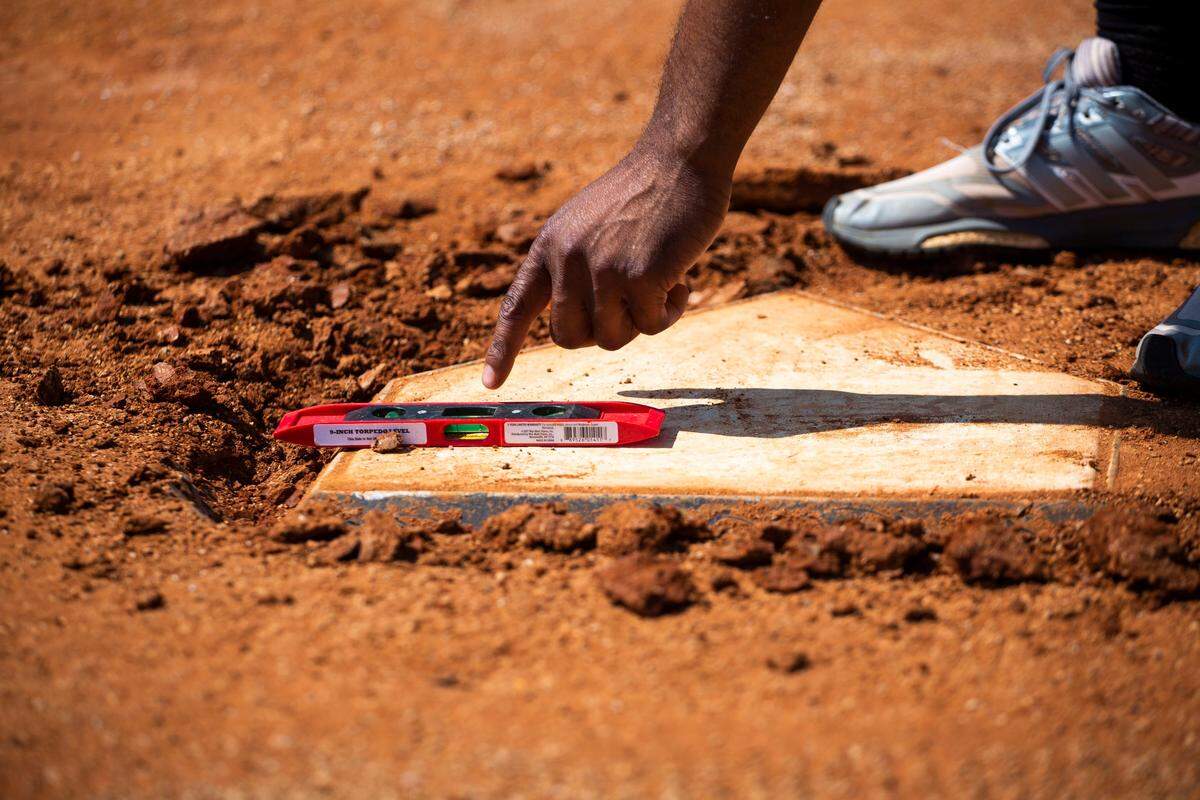 Lexington Legends head groundskeeper Jonathan Youngblood and his assistant Dustin Spiegel worked on leveling home plate before a game at Whitaker Bank Ballpark this summer.