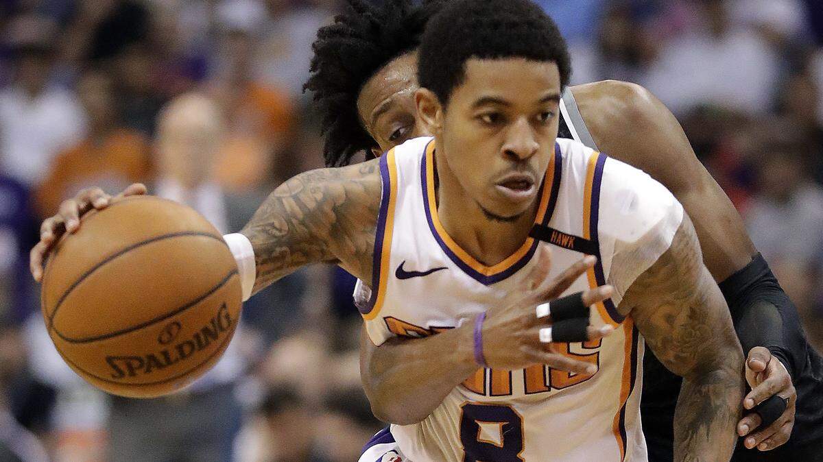 Sacramento Kings guard De'Aaron Fox tried to strip the ball from Phoenix Suns guard Tyler Ulis (8) during their game April 3, 2018, in Phoenix. Ulis was released from the Suns on Saturday.