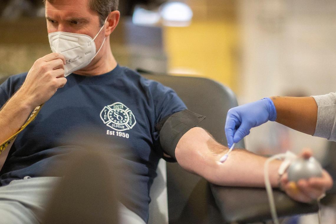 Kentucky Gov. Andy Beshear donates blood in the Kentucky state Capitol on Friday, Dec. 17, 2021, in the wake of last weekend’s historic tornado storms in Western Kentucky.