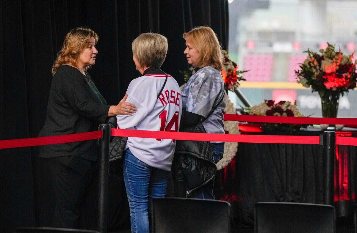 Fawn Rose, left, the eldest daughter of Pete Rose, speaks with Terri Toops and her sister Sherri Shadday, both of Osgood, Indiana, as the Cincinnati Reds hosted a daylong visitation for Pete Rose at Great American Ball Park Sunday, November 10, 2024. Rose, MLB's all-time hits leader died in September.