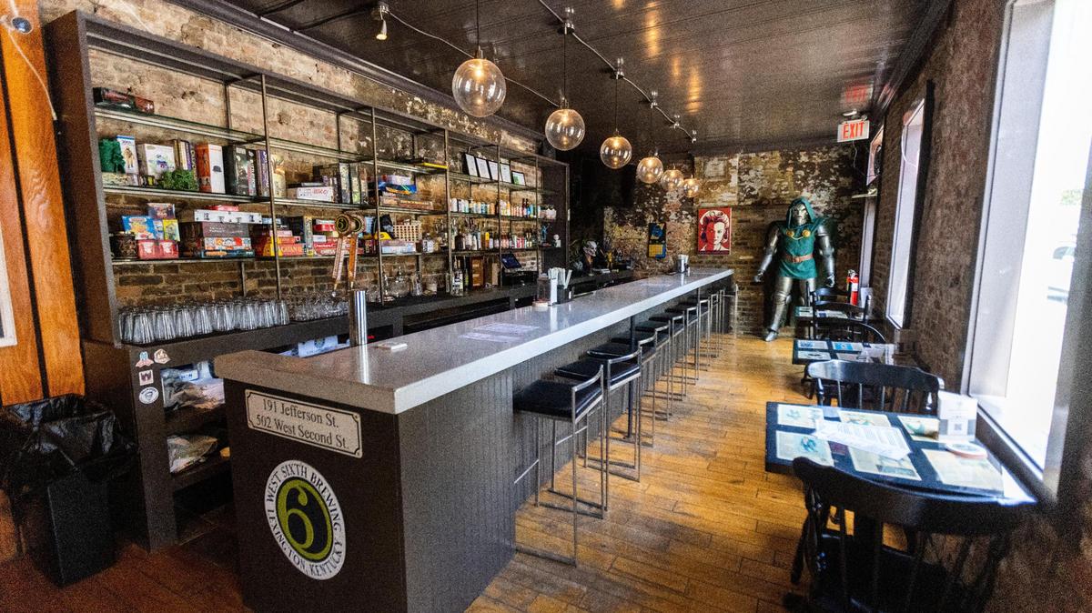The bar area of Villainous tabletop gaming pub on Jefferson Street includes several board games behind the bar available to borrow for patrons.