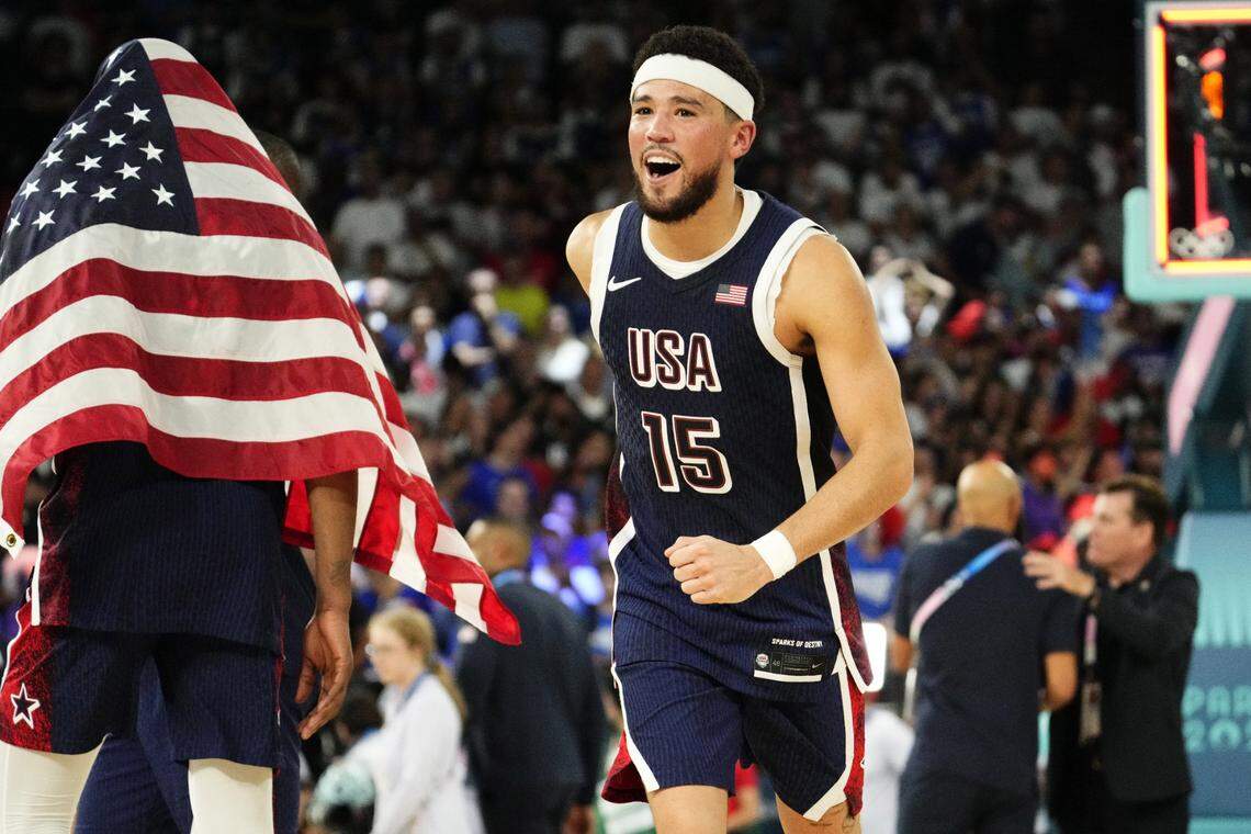 Aug 10, 2024; Paris, France; United States guard Devin Booker (15) celebrates after defeating France in the men's basketball gold medal game during the Paris 2024 Olympic Summer Games at Accor Arena. Mandatory Credit: Rob Schumacher-USA TODAY Sports
