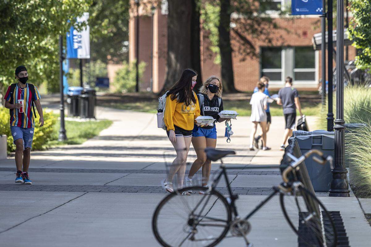 Students walk along the University of Kentucky campus in Lexington, Ky., on Wednesday, Aug. 19, 2020, during the academic year’s first week of classes.