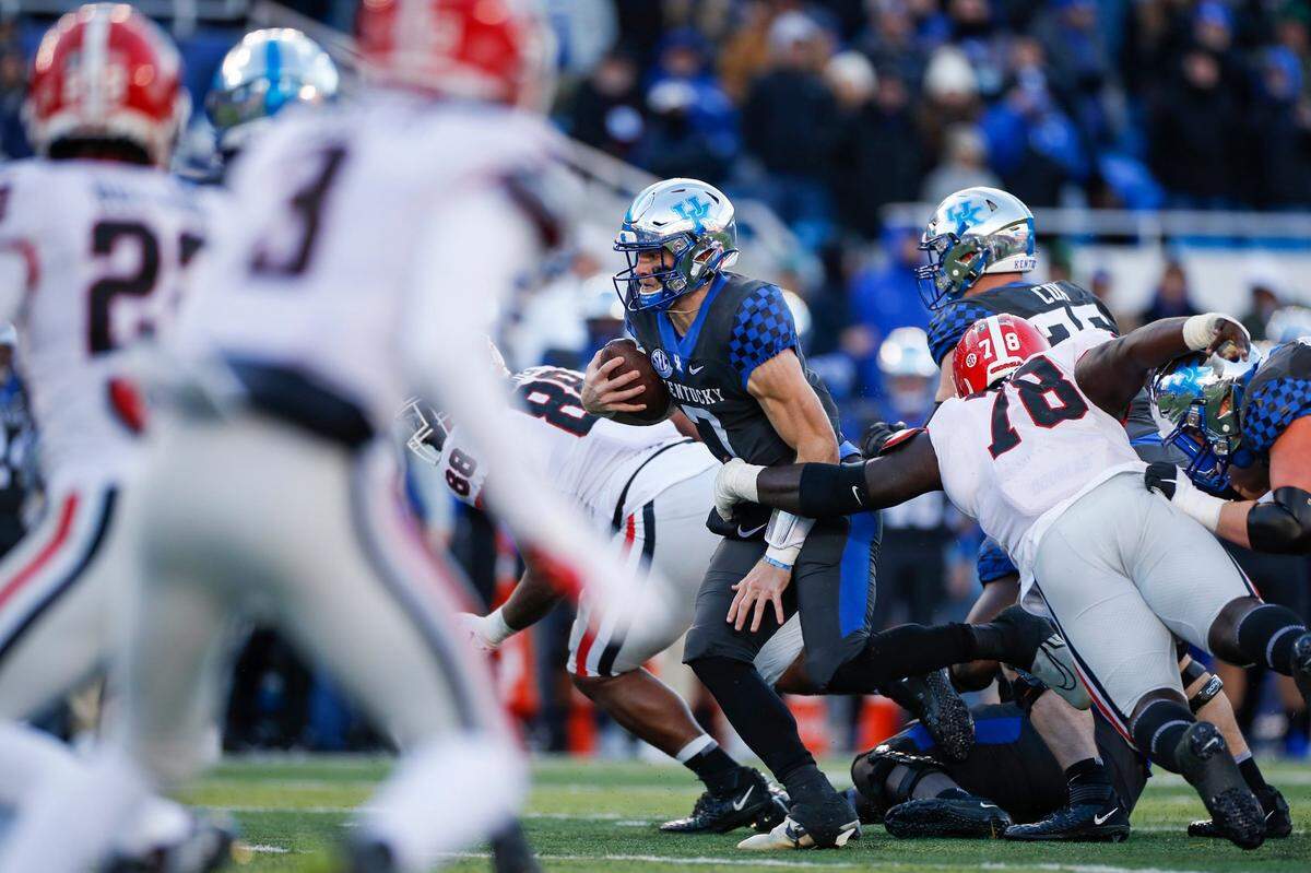 Kentucky quarterback Will Levis runs the ball against Georgia during Saturday’s game at Kroger Field. He threw for 206 yards and gained a season-high 26 on the ground.