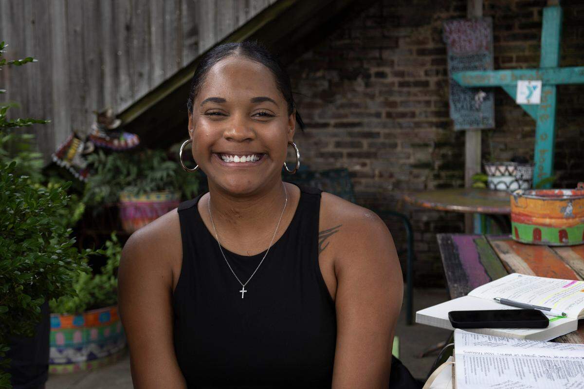 Damesha Nealy, a 30-year-old Winburn resident, poses for a photo outside of Third Street Stuff & Coffee in Lexington, Kentucky on June 19, 2024.