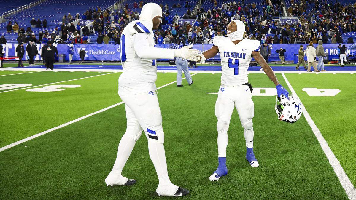 Paducah Tilghman's Martels Carter (4) and Jarvis Strickland (70) celebrate after winning the Class 4A state championship at Kroger Field in Lexington last December. Strickland recently committed to Louisville. Martels is a Kentucky freshman.