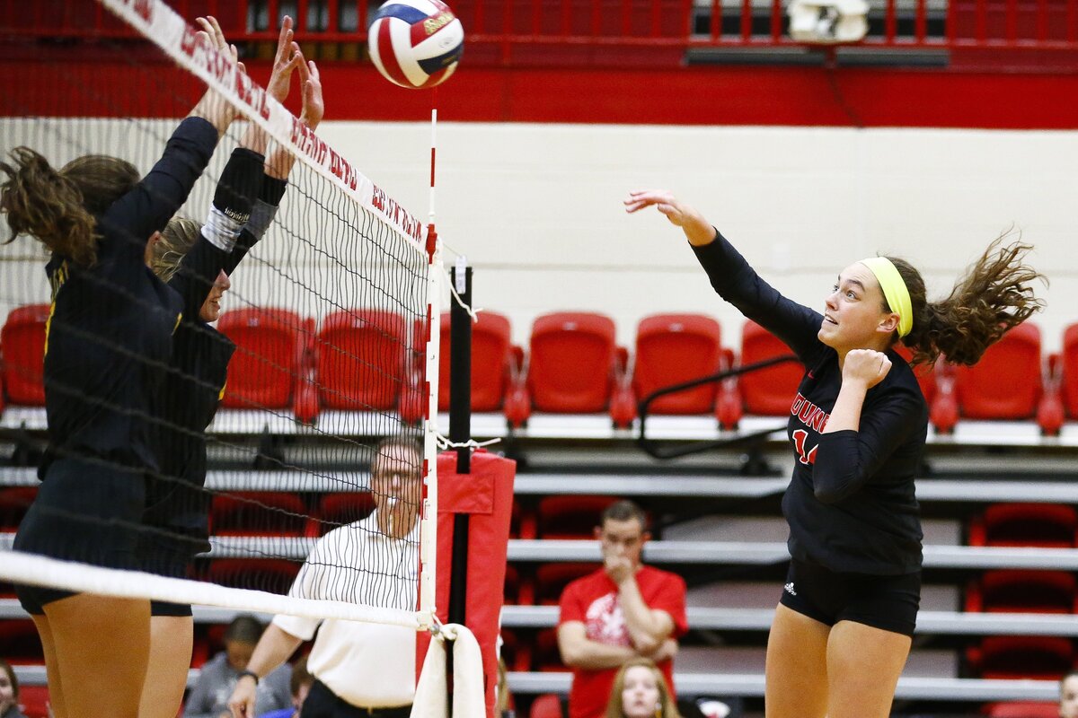 Paul Laurence Dunbar’s Eleanor Davis (14) hit the ball past Henry Clay’s Sydney Baker (11) and Henry Clay’s Emma Shadwick (2) during the 11th Region volleyball tournament semifinals Wednesday at Scott County High School in Georgetown. Paul Laurence Dunbar beat Henry Clay 3-0.