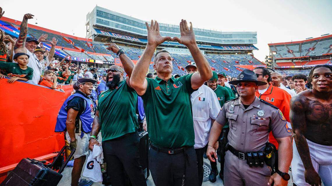 Miami head coach Mario Cristobal flashes the U as fans celebrate the Hurricanes defeating Florida Gators in Gainesville on Saturday.