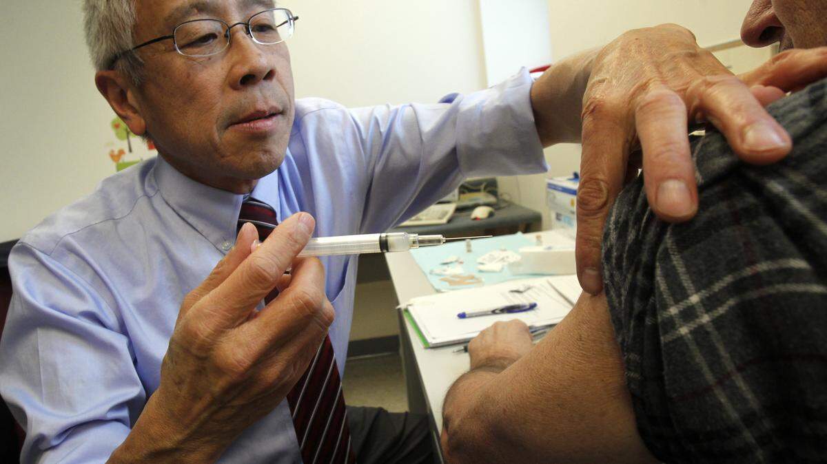 Health Commissioner Dr. Harry Chen gives a whooping cough vaccine on Wednesday, Dec. 19, 2012 in Barre, Vt. The Vermont Health Department is offering free vaccines at clinics around the state to prevent the spread of whooping cough which has reached epidemic numbers in Vermont. The state recommends that everyone 11-years-olds and older get a Tdap vaccine booster for tetanus, diphtheria and pertussis or whooping cough.(AP Photo/Toby Talbot)