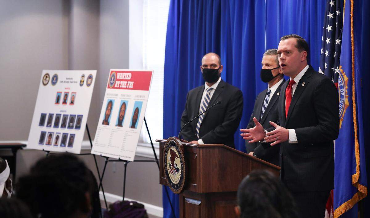 Russell Coleman, right, U.S. Attorney for the Western District of Kentucky, was joined by other officials on July 28, 2020 during a press conference to announce charges in gang-related activity at the United States Attorney’s Office in downtown Louisville.