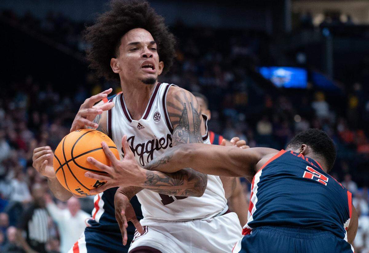 Texas A&M’s Andersson Garcia (11) is fouled by Mississippi’s TJ Caldwell (2) late in their second-round game of the SEC Men’s Basketball Tournament at Bridgestone Arena in Nashville on Thursday night.