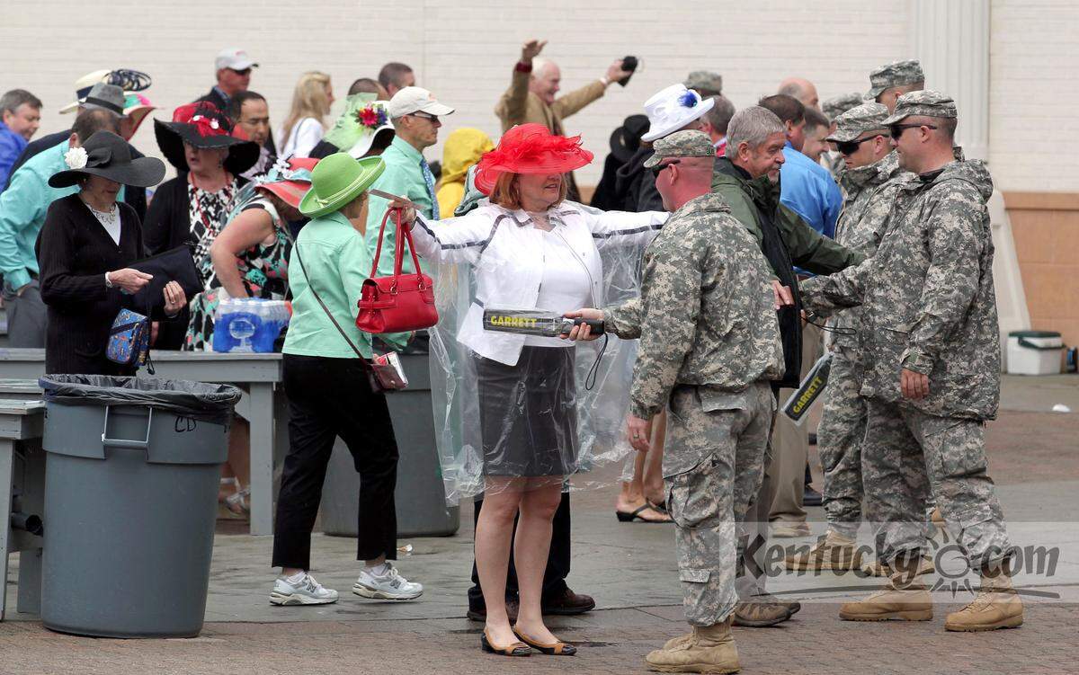 Patrons are screened with wands as as they entered gate 1 before the 139th running of the Kentucky Derby at Churchill Downs in Louisville, Ky. Saturday May 4, 2013. Security measures have been increased this year to include closer inspections of bags, purses, and the use of security wands. Photo by Charles Bertram | Staff