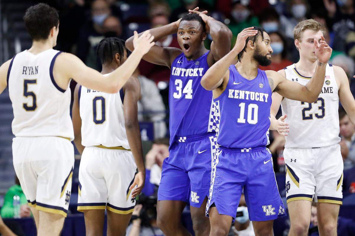 Kentucky’s Oscar Tshiebwe (34) and Davion Mintz (10) reacted to a foul call near Notre Dame’s Cormac Ryan (5), Blake Wesley (0) and Dane Goodwin (23) during Saturday night’s game in South Bend, Ind..
