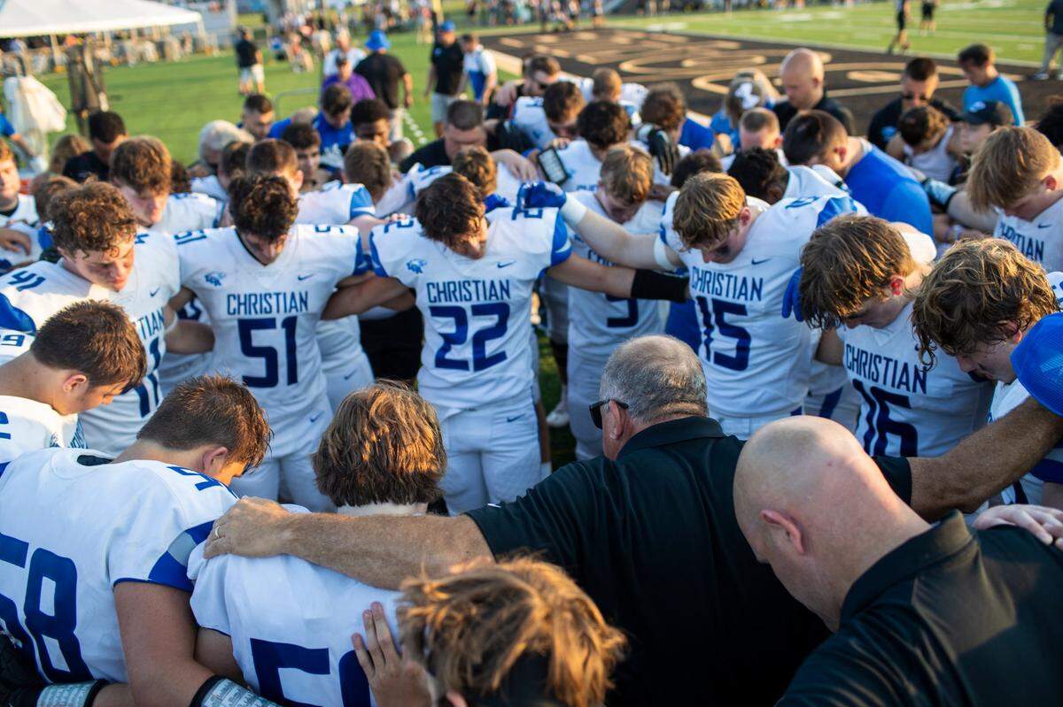 Lexington Christian Academy head coach Doug Charles said a prayer with his players after a victory over Mercer County at Boyle County High School in Danville last month.