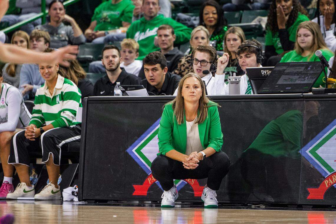 Former Transylvania University women’s basketball coach Juli Fulks, kneeling, will lead the Thundering Herd against No. 23 Kentucky on Saturday in Huntington, West Virginia.