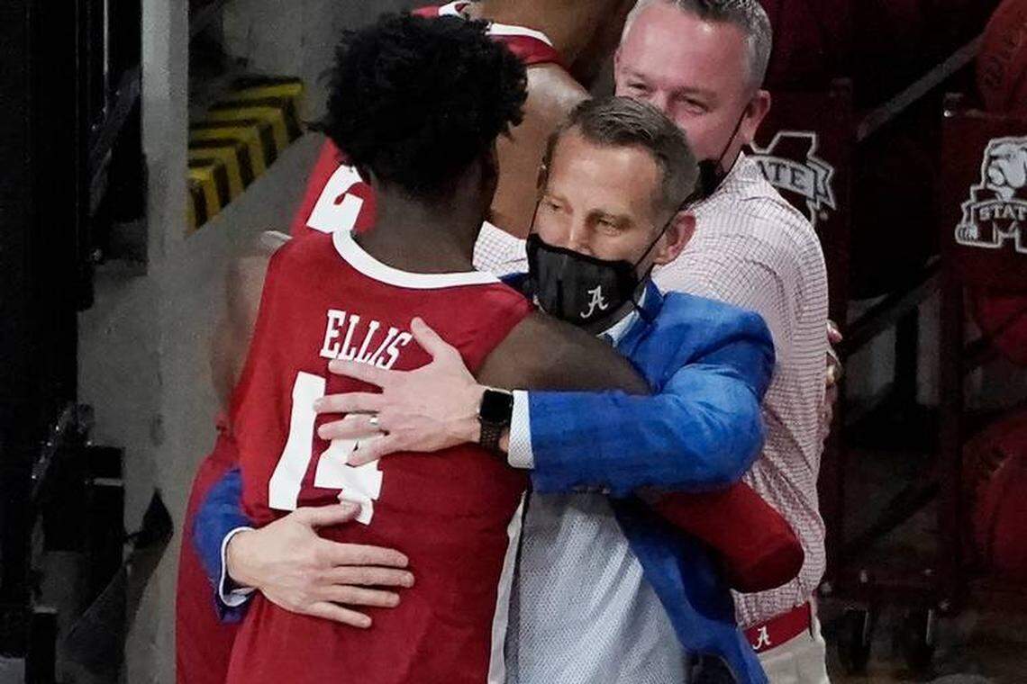 Alabama head coach Nate Oats hugged guard Keon Ellis (14) after the Crimson Tide’s win over Mississippi State on Feb. 27 secured the SEC regular-season title.