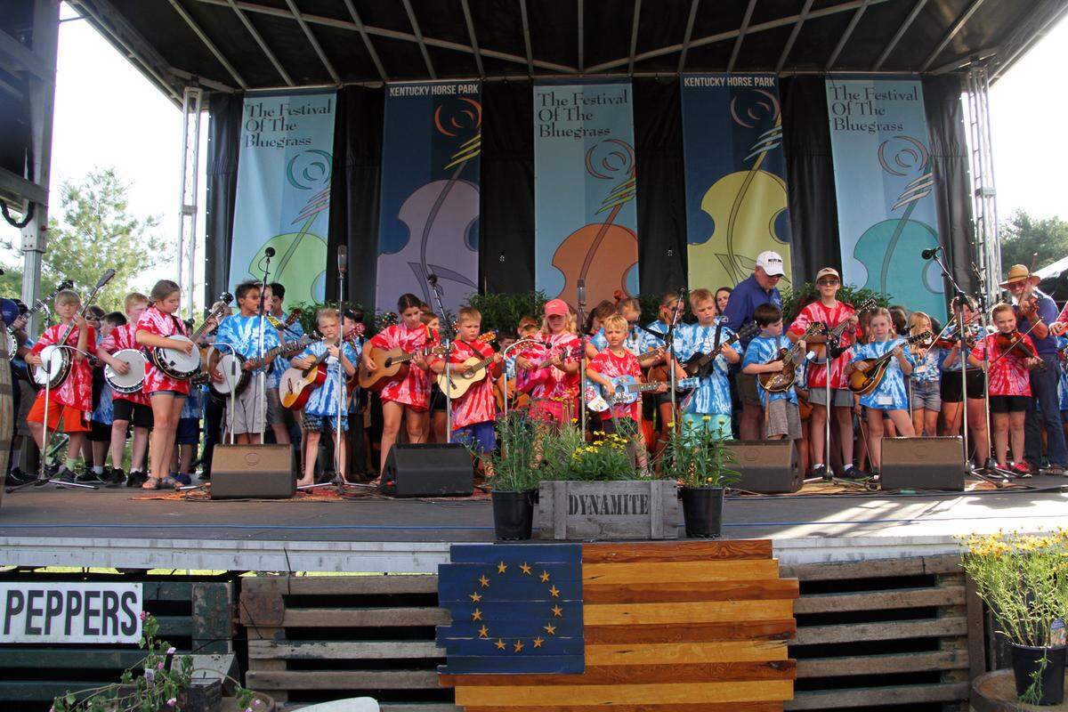 Kids from the bluegrass camp open the annual Festival of the Bluegrass at the Kentucky Horse Park. Events like the camp and the campground scene help to set this festival apart from others.