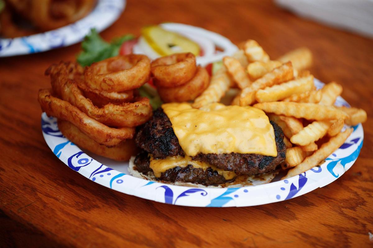 The double cheeseburger, fully dressed with onion rings and crinkle fries at Waterfront Grille & Gathering in Winchester. Other sides offered with the double cheese burger includes homemade pasta salad or home made coleslaw.