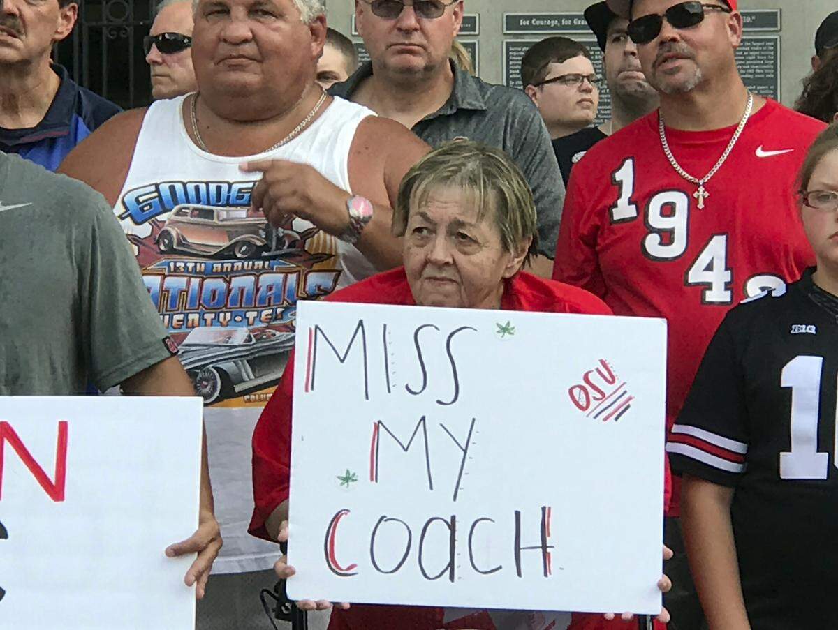 Ohio State fans listened to a speaker at a rally in support of Coach Urban Meyer outside Ohio Stadium in Columbus, Ohio, on Aug. 6.