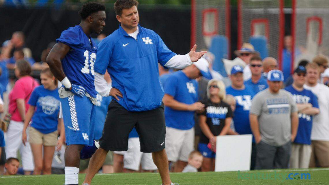 UK offensive coordinator Shannon Dawson chats with Stanley "Boom" Williams on the Tim Couch Practice Fields during UK Football Fan Day in Lexington, Ky., Saturday, August 8, 2015. Photo by Matt Goins