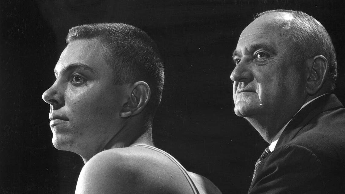 Kentucky men’s basketball coach Adolph Rupp, right, and his son, Herky Rupp, watch a practice session in 1959. Rupp coached the Wildcats from 1930 to 1972.